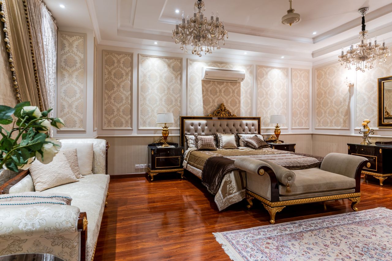 Crafting Captivating Headlines: Your awesome post title goes here Opulent bedroom featuring a grand bed, chandeliers, and rich decor elements.
